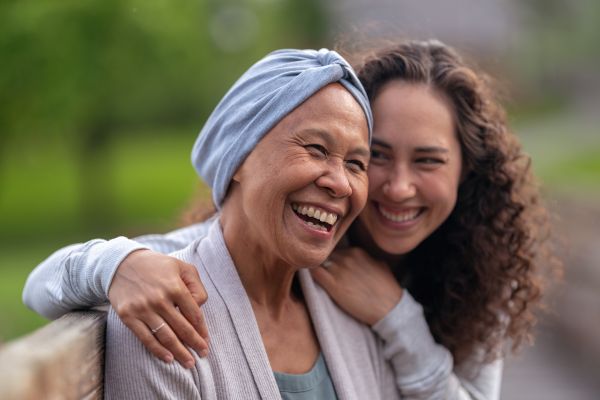 Happy-senior-woman-with-cancer-laughing-with-daughter